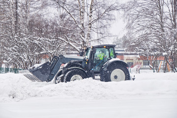 Tractor clearing street after a snow storm