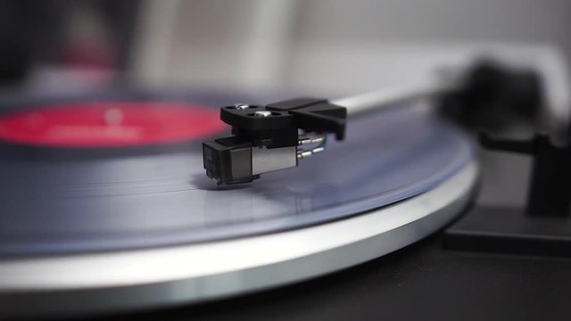 Clear vinyl spinns on the turntable, the headshell drops down on the vinyl and the record begins to play