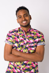 Happy young handsome African tourist man smiling with arms crossed