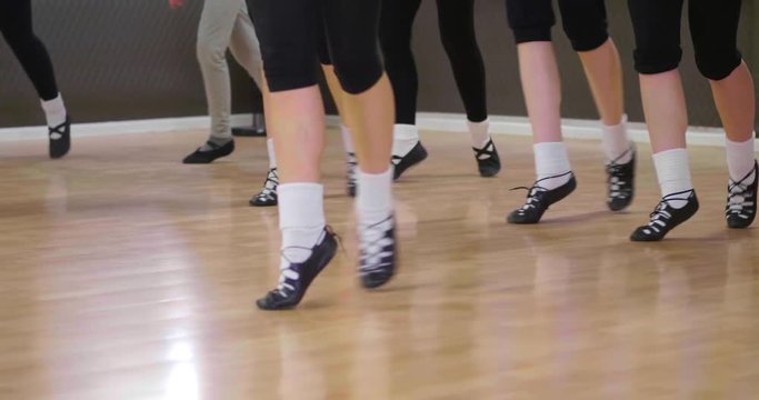 St. Patrick's Day celebration with dancers tap dancing to Irish traditional steps in the studio 
(medium shot)