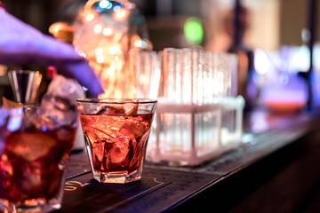 Alcoholic drinks and cocktails in glasses on the bar. A party