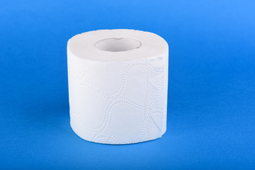 Roll of toilet paper isolated on blue background