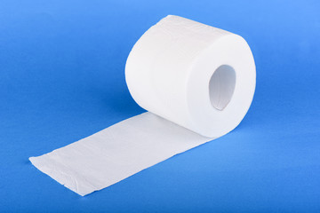 Roll of toilet paper isolated on blue background