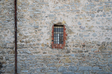 Stadtmauer mit vergittertem Fenster