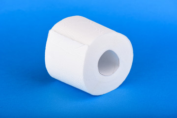 Roll of toilet paper isolated on blue background