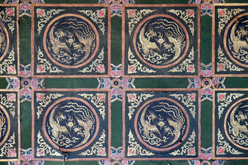 An ornate painted ceiling on a building in the Forbidden City in Beijing, China
