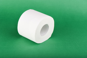 Roll of toilet paper isolated on green background
