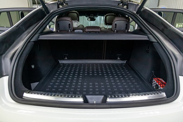 White luggage space in the body of the SUV hatchback with open rear doors and leather interior