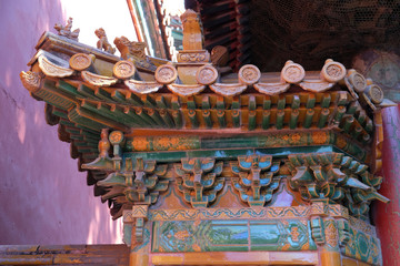 Fototapeta na wymiar An ornate painted roof on a building in the Forbidden City in Beijing, China