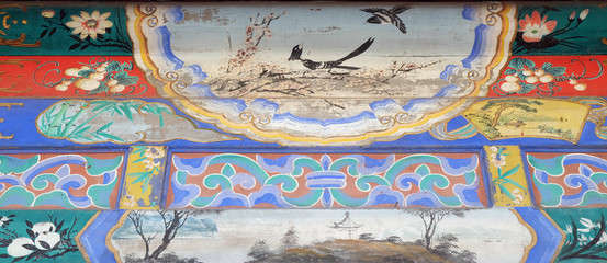 An ornate painted ceiling on a building in the Forbidden City in Beijing, China