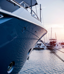 View of harbor with yachts details. Beautiful sunset sky in the marina bay.