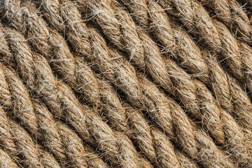 A beautiful horizontal pattern texture from yellow natural flax rope on dark background
