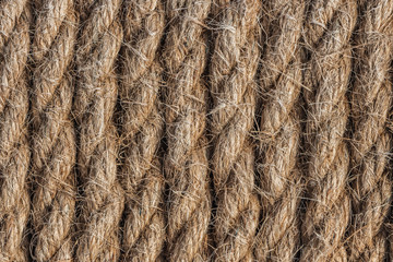 A beautiful horizontal pattern texture from yellow natural flax rope on dark background