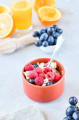 oatmeal with organic blueberries and raspberries, fresh orange juice and grapes. light background, selective focus and copy space, Breakfast concept. diet, healthy food