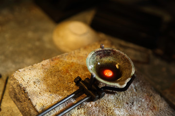 Closeup of melted precious metal in a bowl