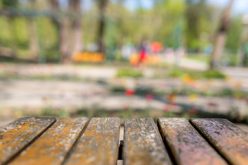 Wood table top on blur green background of trees in the park - can be used for display or montage your products