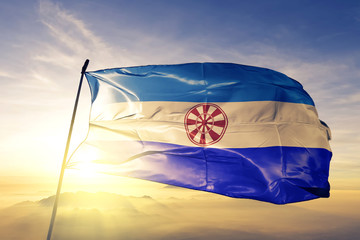 Evenkia District of Russia flag waving on the top sunrise mist fog