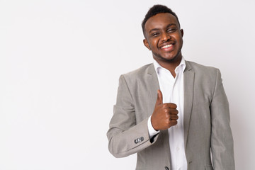 Portrait of happy young African businessman giving thumbs up