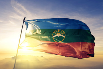 Karachay-Cherkessia Republic of Russia flag waving on the top sunrise mist fog