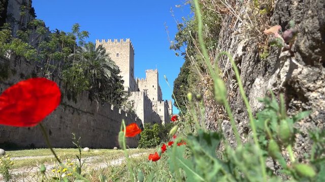Rhodes, Greece - 21st of April 2018: 4K Touring old town of Rhodes - Poppy flowers and fortress wall