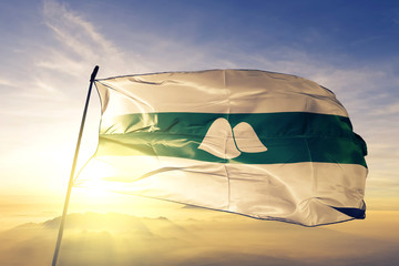 Kurgan oblast of Russia flag waving on the top sunrise mist fog