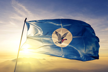 Taymyr Autonomous Okrug of Russia flag waving on the top sunrise mist fog