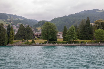 Fototapeta na wymiar View on lake Thun and mountains from ship in city Spiez, Switzerland