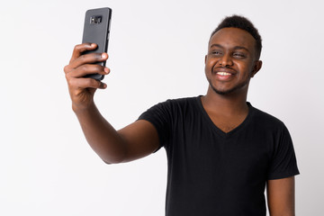 Portrait of happy young African man taking selfie