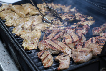 Sizzling, delicious grilled steak and chicken hot off the barbecue at an outdoor garden party
