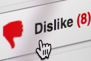 Computer screen with dislike button being clicked.