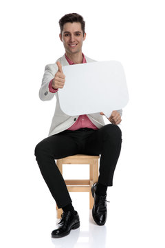 man makes the ok sign while holding a speech bubble