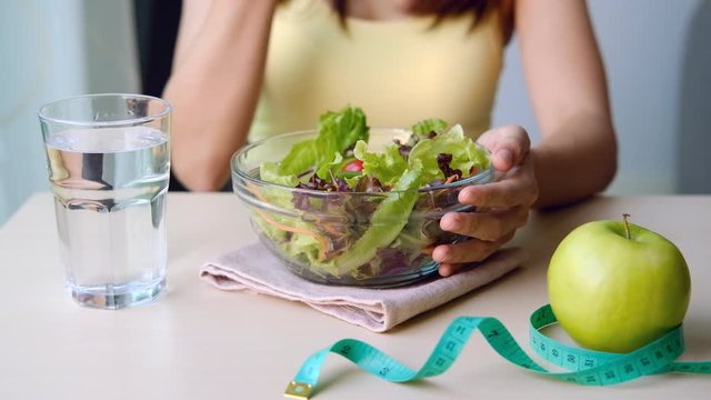 Young woman eating homemade healthy salad at home, Healthy lifestyle, diet concept
