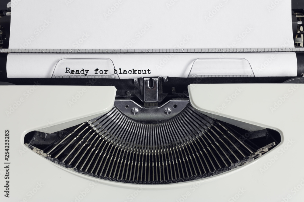 Fototapete old retro obsolete white typewriter with close-up typing text ready for blackout as heading on paper