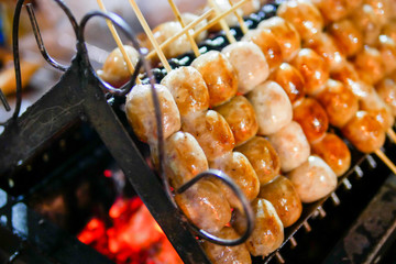 Isaan sausage being grilled on the traditional stove that be a part of street food in Thailand