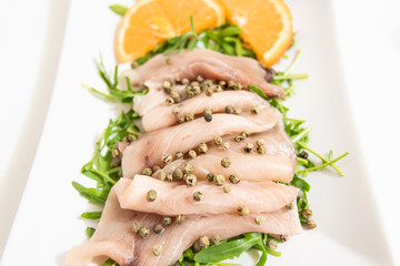 Carpaccio of fresh Mediterranean swordfish with green pepper, chives and a few drops of orange juice