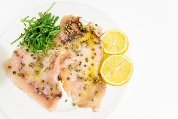 A delicious carpaccio of fresh swordfish, seasoned with extra virgin olive oil, chives and a few drops of lemon juice