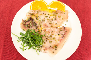 A delicious carpaccio of fresh swordfish, seasoned with extra virgin olive oil, chives and a few drops of lemon juice