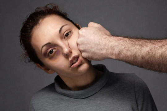 A man's fist hits a woman in the face. Domestic violence