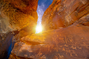 Ancient rock art petroglyphs on the wall of a cave in Valley of Fire State Park, Nevada. Caveman drawings.
