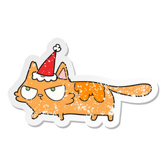 distressed sticker cartoon of a angry cat wearing santa hat