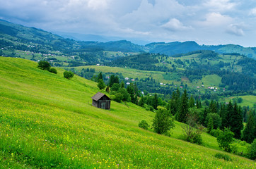 wooden house on a slope in the mountains far from the village