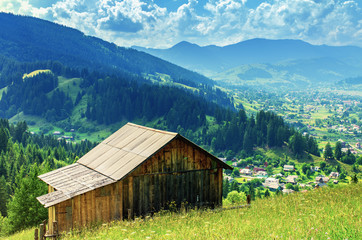 wooden house on a slope in the mountains far from the village