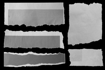 Torn papers on black