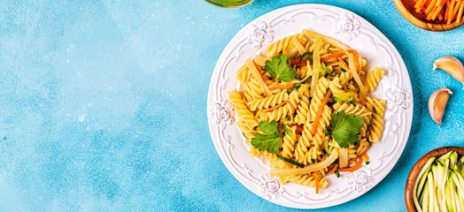 Fusilli pasta with squid, zucchini and carrots