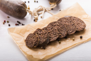Food, meat and delicious concept - sausages made with horse meat with species and vegetables