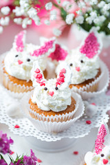 Bunny cupcakes on a white cake stand. Easter dessert