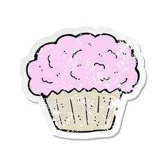 retro distressed sticker of a cartoon cupcake