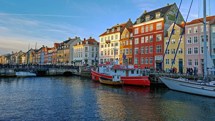 Fototapeta premium Nyhavn waterfront, canal and entertainment district with colorful houses, buildings, ships, yachts and boats in Old Town of Copenhagen, Denmark
