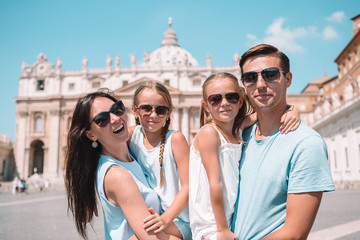 Happy family at St. Peter's Basilica church in Vatican city. - Powered by Adobe
