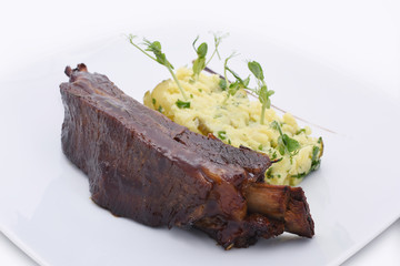 Juicy delicious ribs with sauce. With vegetables. On a white background beautiful food